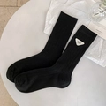 Minimalist black ribbed crew socks with a stylish white triangular logo patch design - One Size / Black