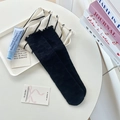 Black crew socks with ruffled cuffs and bow pattern displayed with lifestyle props - One Size / Black