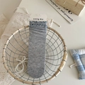 Gray crew socks with colorful glitter dots and blue ruffled edges in a cozy basket - Gray Blue Frilly Edge
