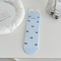 Light blue knit crew socks with grey bow jacquard pattern and ruffled wave edge - Blue