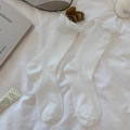 White cotton ribbed crew socks featuring delicate ruffle cuffs in a minimalist style - One Size / White