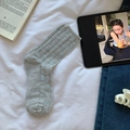 Light gray crew socks with blue heart pattern and ribbed texture in casual flat lay - One Size / Gray