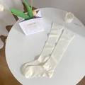 Japanese ballet style milk white calf socks with ribbed knit pattern on white table - Beige