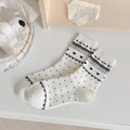 Off-white crew socks featuring black hearts and polka dots with a cute bow accent - One Size / White Heart