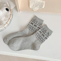 Light gray mid-calf cotton socks featuring black bow and heart patterns in a flat lay - One Size / Grey Bow