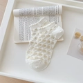 White hollow-out lace ankle socks with heart patterns and ruffle cuffs on a book background - One Size / Argyle (White)
