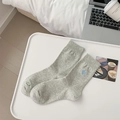 Light gray cotton mid-calf socks with light blue heart embroidery in a lifestyle setting - Grey with Hearts