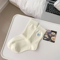Off-white crew socks with blue heart embroidery in a minimalist aesthetic scene - White With Heart