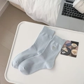Light blue crew socks with heart embroidery detail and ribbed cuffs in a casual setting - Blue