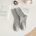 Light grey speckled crew socks with ribbed texture in a cozy minimalist setting - Light Gray