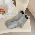 Grey knit crew socks with cute cat embroidery and colorful flecks on a chair - One Size / Black Cat Pom-pom Style / Gray
