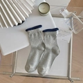 Light gray ribbed crew socks featuring dark blue bubble lace cuffs on a stylish tabletop - One Size / Vertical Ribbed/Rolled Edge