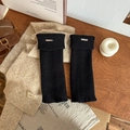 Thick black ribbed knit leg warmers with metallic logo detail for winter fashion - Black