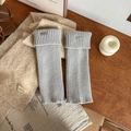 Chic grey ribbed knit leg warmers with metallic logo tag and stylish warm texture - Light Gray