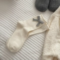 Beige cotton crew socks with grey knit bow detail in a cozy home setting flat lay - One Size / White