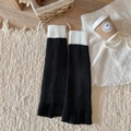 Knitted leg warmers in black and white color block style with ribbed texture - One Size / Black