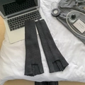 Deep grey knitted leg warmers with ribbed texture and notch detail on a white bed - One Size / Dark Gray