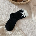 Cozy black knit socks with colorful dots, white faux fur trim and cute bow detail - One Size / Black