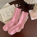 Pink sweet wool socks with ruffled cuffs and ribbed knit texture in a cozy setting - Pink