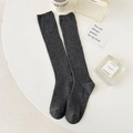 Deep grey knit mid-calf socks with vertical ribbed texture on a white table setting - One Size / Dark Gray