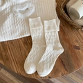 White winter wool socks with textured floral relief pattern in a cozy lifestyle setting - One Size / White