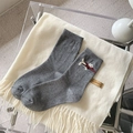 Dark gray knit socks featuring embroidered white dog motif and red ribbon bow accents - Single Dog Embroidery With Red Bow