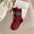 Deep red striped wool socks in retro collegiate style on an open vintage book - One Size / Red