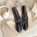 Deep grey knit socks with red heart and letter embroidery against a soft cozy background - One Size / Dark Gray