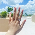 S925 sterling silver infinity ring with cushion cut zircon on hand in outdoor sunlight - Style X