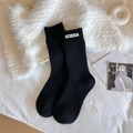 Black ribbed mid-calf warm socks with white letter label and soft knit texture - One Size / Black
