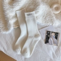 White crew socks in ribbed cotton knit featuring minimalist fabric label and solid color - One Size / White