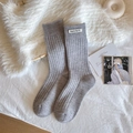 Japanese style ribbed grey mid-calf socks with white cloth label on fuzzy background - One Size / Light Gray