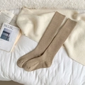 Minimalist khaki calf socks with vertical ribs for warmth, displayed in a cozy setting - Light Coffee