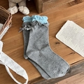 Grey knit socks with blue ruffle trim and a delicate bow detail on a wooden surface - One Size / Dark Gray