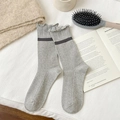 Light gray knit crew socks with ruffled edge and dark gray stripe in a cozy setting - One Size / Light Gray