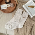 Speckled oatmeal wool socks featuring cute brown bear embroidery in a slouchy style - White