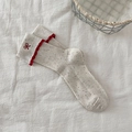 Beige confetti knit crew socks for women featuring red ruffle trim and bow embroidery - Cream