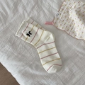 Striped cotton socks with pink ruffles and a black bow detail in cream white - White Cuff