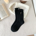 Thick black wool crew socks with white bow embroidery and vintage cable knit texture - Black
