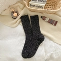 Thick heather grey knitted wool socks for winter with warm ribbed cuffs in cozy home setting - One Size / Black