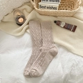 Winter thermal cable knit wool socks for women in beige shown in a cozy home setting - One Size / Khaki