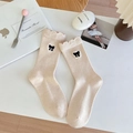 Japanese style beige wool socks with black bow embroidery and scalloped ribbed cuffs - Off-white
