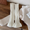 White knitted ballet core leg warmers with ribbed texture and ruffled lettuce hem flare - White
