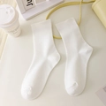 Classic white mid-calf socks in soft cotton fabric displayed on a minimalist table - White
