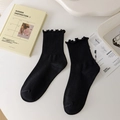 Classic solid black mid-calf socks with ruffle trim and vertical ribbed texture - One Size / Black