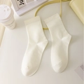 Minimalist creamy white mid-calf socks shown in a stylish minimalist setting - Beige