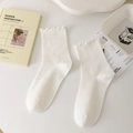 Creamy white mid-calf socks featuring delicate ruffled lace trim and ribbed cotton texture - One Size / White