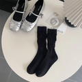 Black mesh slouch socks for women with ribbed texture paired with silver Mary Jane shoes - Small Flower Black