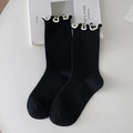 Women's black ribbed crew socks with white ruffled trim edge and cotton knit texture - Black