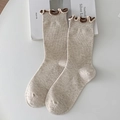 Oatmeal ribbed knit mid-calf socks with vintage ruffled cuffs on white background - Khaki